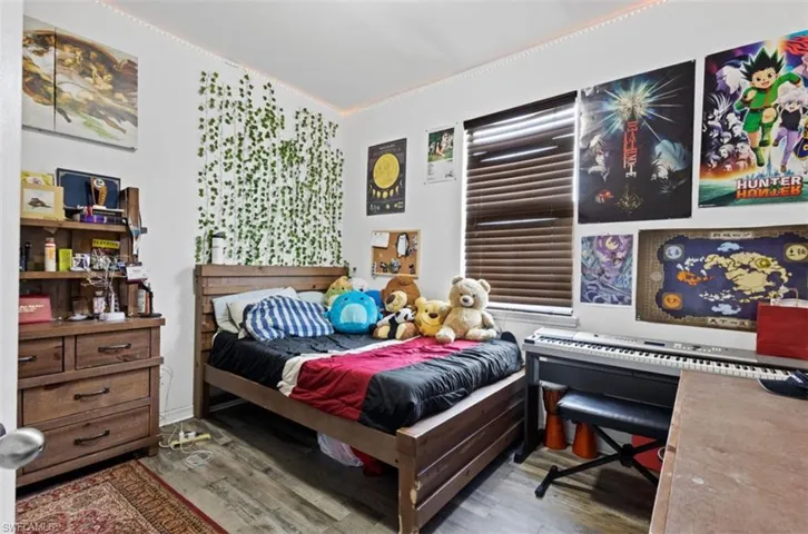 Bedroom with wood-type flooring