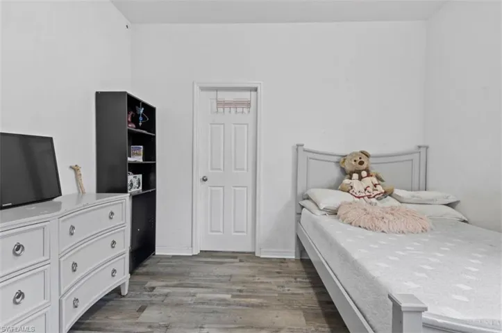 Bedroom with wood-type flooring