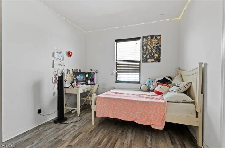 Bedroom featuring crown molding and hardwood / wood-style flooring