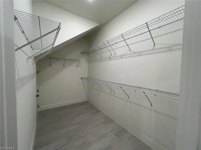 Spacious closet featuring light wood-type flooring