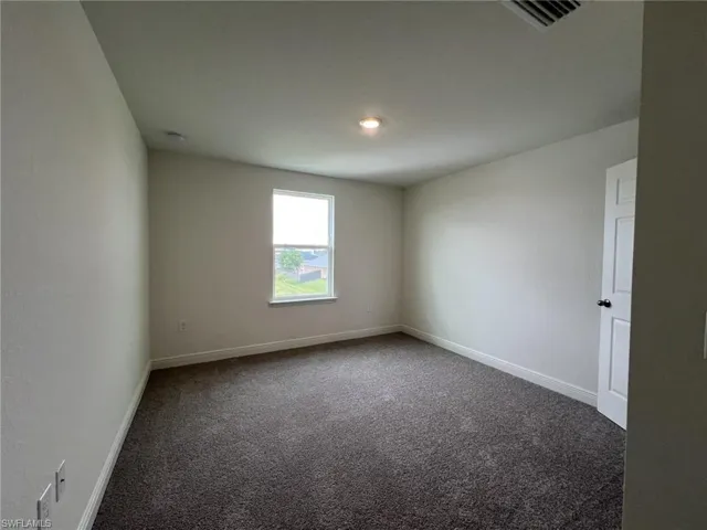 Spare room with carpet flooring and baseboards