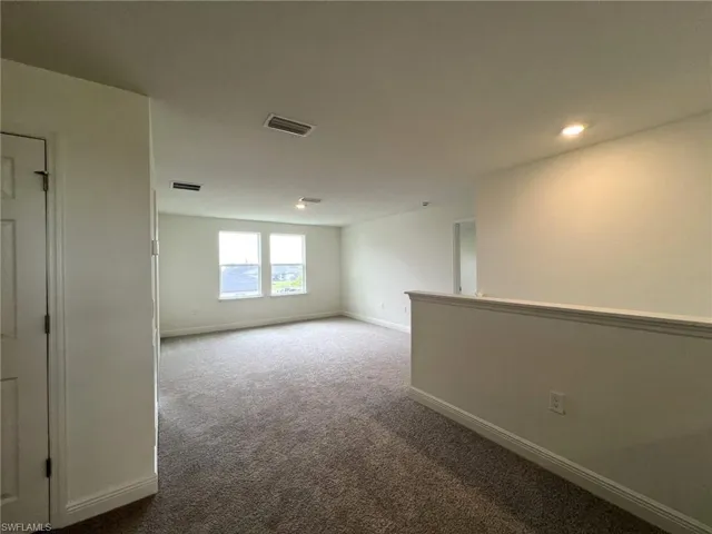 Unfurnished room featuring carpet floors and recessed lighting