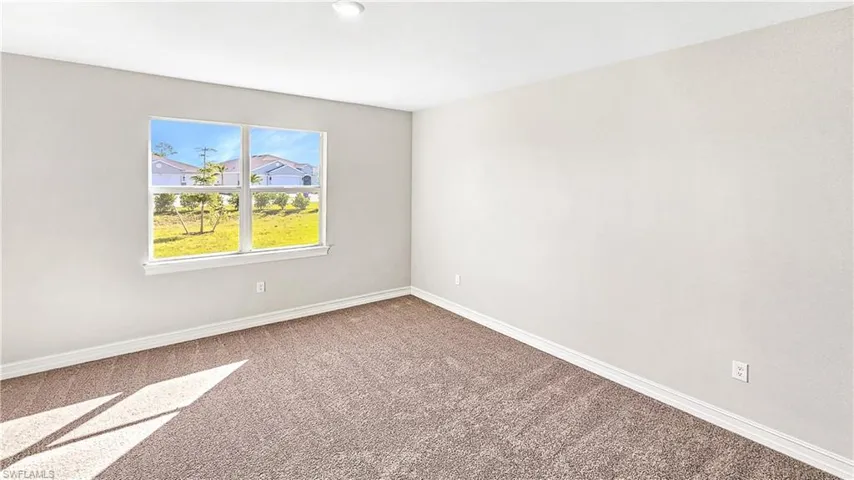 Carpeted empty room with baseboards