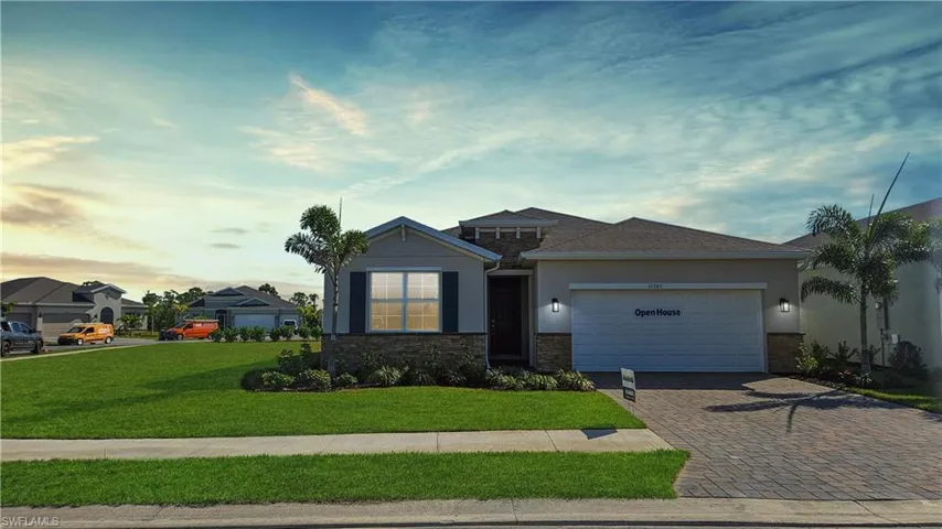 View of front of house with driveway, a garage, a front lawn, and stucco siding