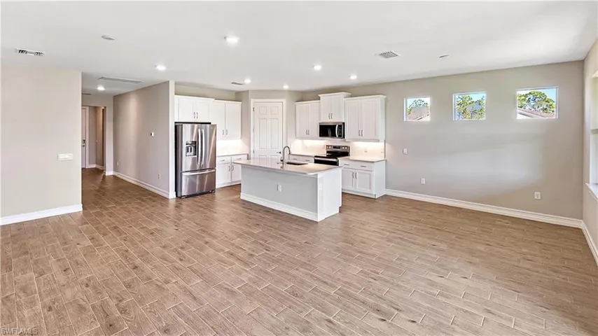 Kitchen featuring visible vents, a sink, stainless steel appliances, and light wood finished floors
