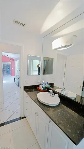 Bathroom with tile patterned floors and vanity