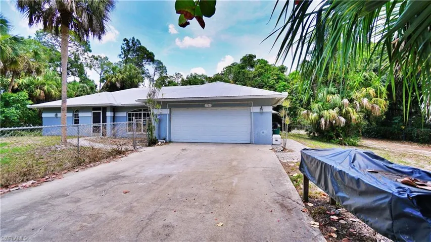 Ranch-style house featuring a garage, stucco siding, and concrete driveway