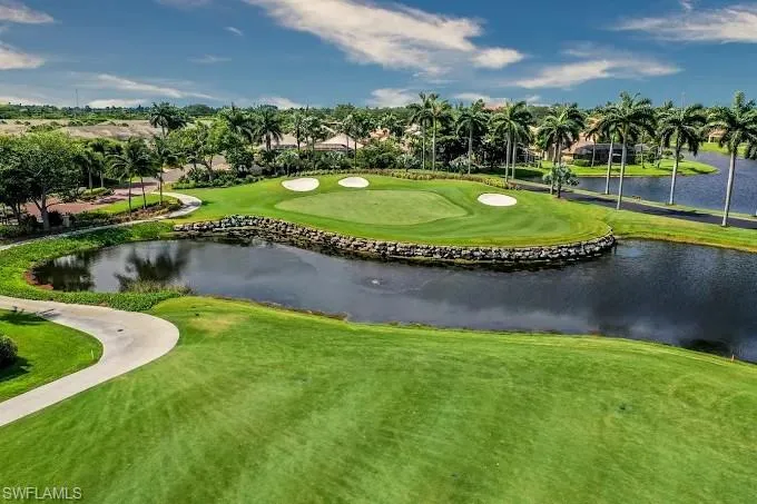 View of home's community with golf course view and a water view