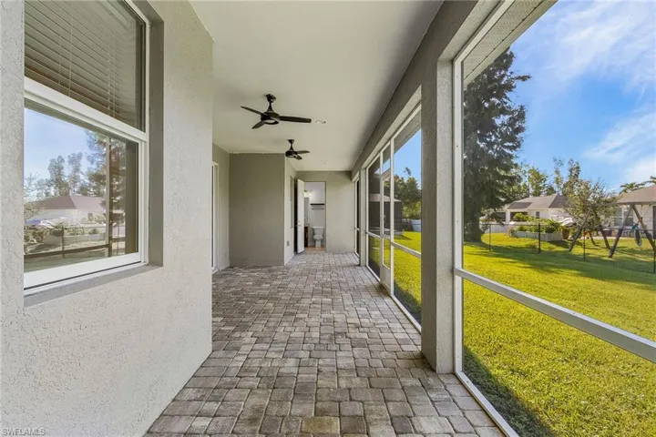 Unfurnished sunroom featuring ceiling fan