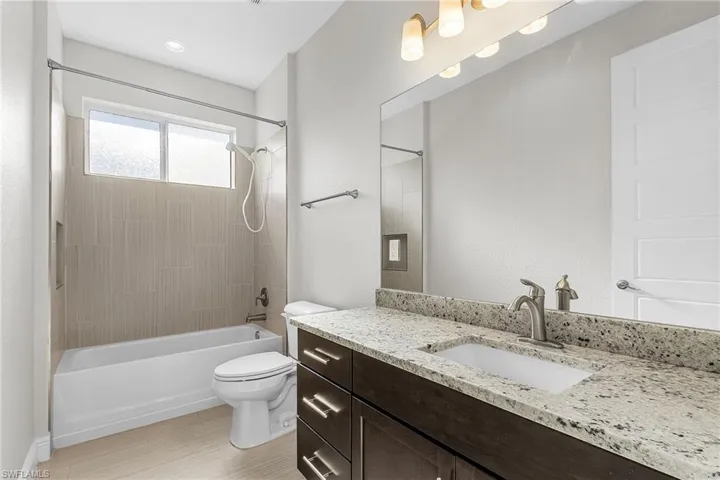 Full bath featuring tub / shower combination and vanity