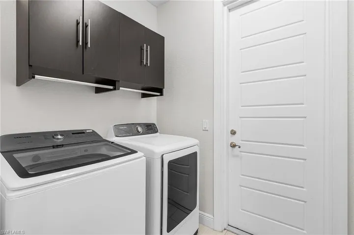 Laundry room with washing machine and dryer and cabinet space