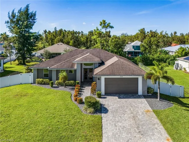 Ranch-style home with a gate, stucco siding, decorative driveway, a garage, and roof with shingles