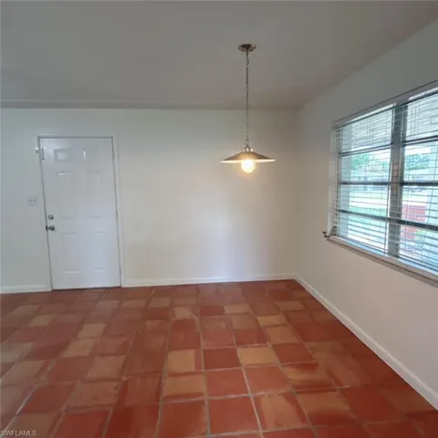 Unfurnished dining area featuring baseboards and light tile patterned floors