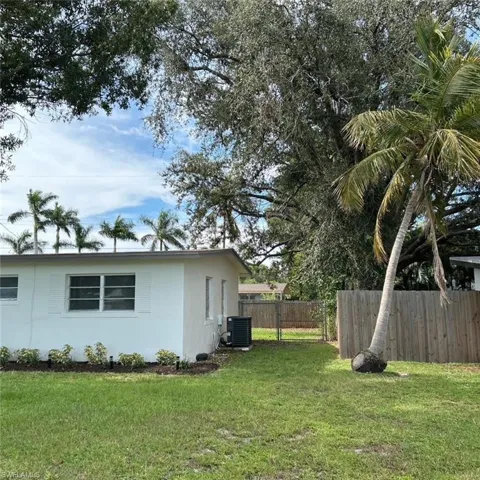 View of side of property featuring stucco siding and a central AC unit