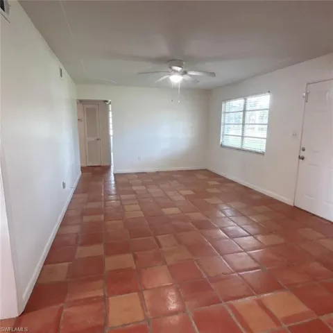 Spare room featuring ceiling fan and light tile patterned floors