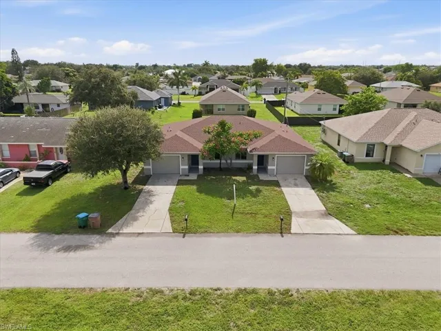 Duplex property featuring a shared roofline and individual garages