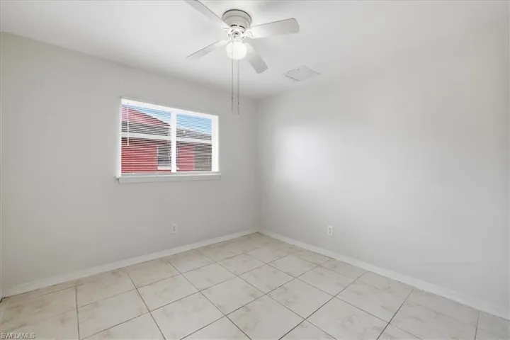 Neutral-toned square tile flooring complements the light wall paint