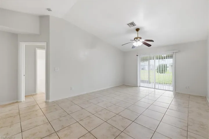 Spacious room with vaulted ceilings and ceramic tile flooring