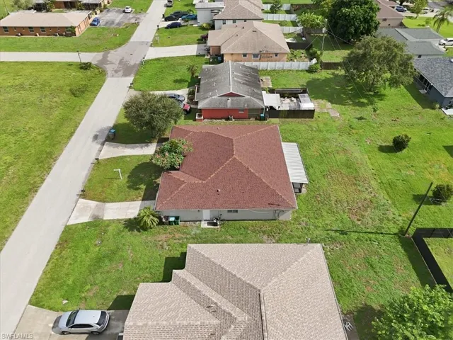 Aerial perspective of a neighborhood with residential structures and green spaces