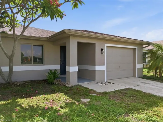 Single-story residence featuring a two-tone stucco exterior, a covered entryway, and an attached single-car garage