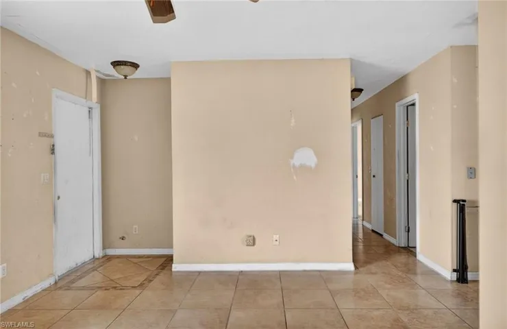 Unfurnished room featuring tile patterned flooring and ceiling fan