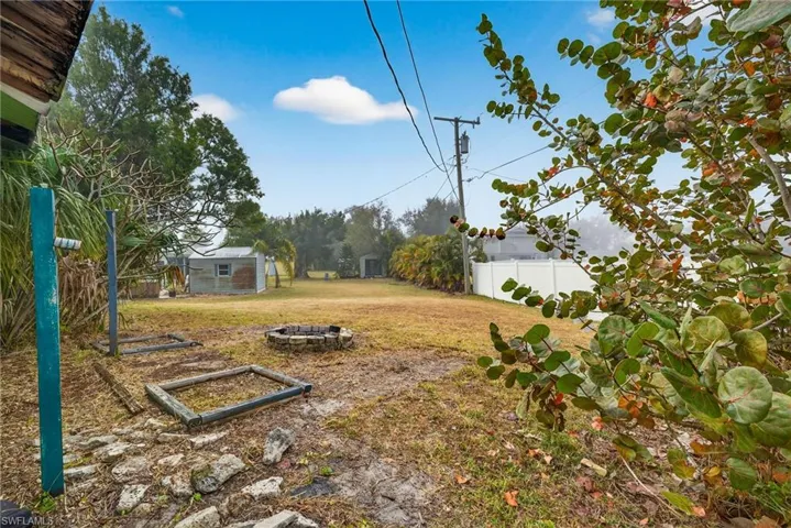 View of yard featuring a fire pit and an outbuilding