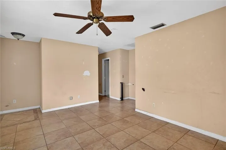 Unfurnished room with a ceiling fan and light tile patterned floors