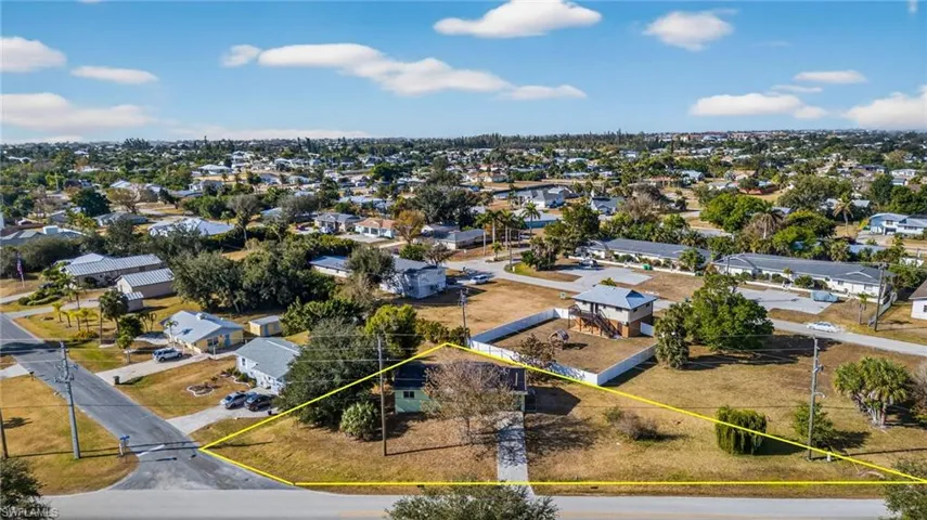 Aerial perspective of suburban area featuring property boundaries highlighted