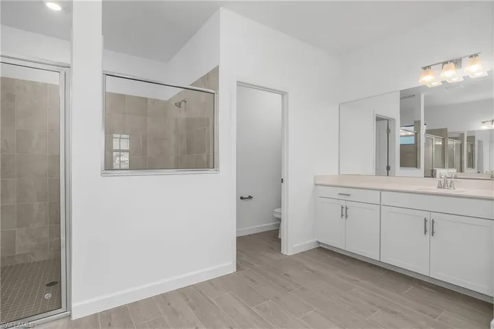 Primary bath with dual sinks, separate water closet, and walk in shower.