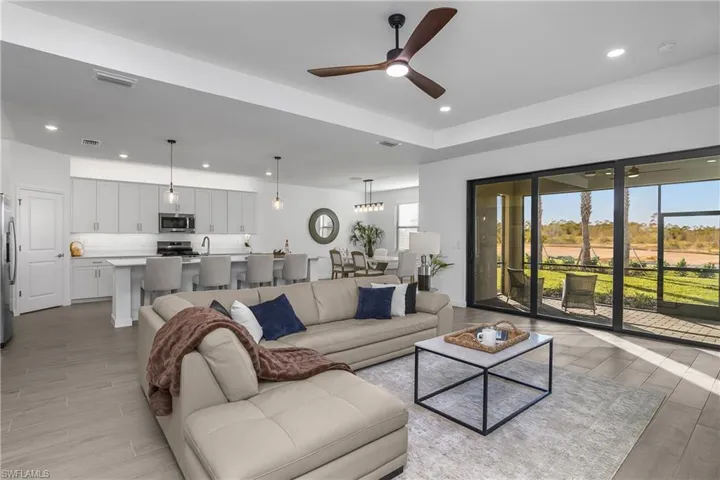 Open living, kitchen and dining area all overlook your private pool/spa and stunning water views. (Photo from nearby staged home)