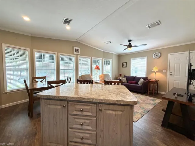 Kitchen island with a light-toned countertop and paneled cabinetry