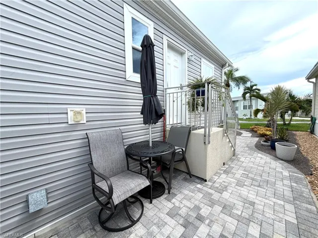 Durable exterior siding, paved patio, and metal railing
