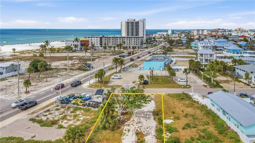 Aerial view of property's location with property boundaries highlighted and a large body of water