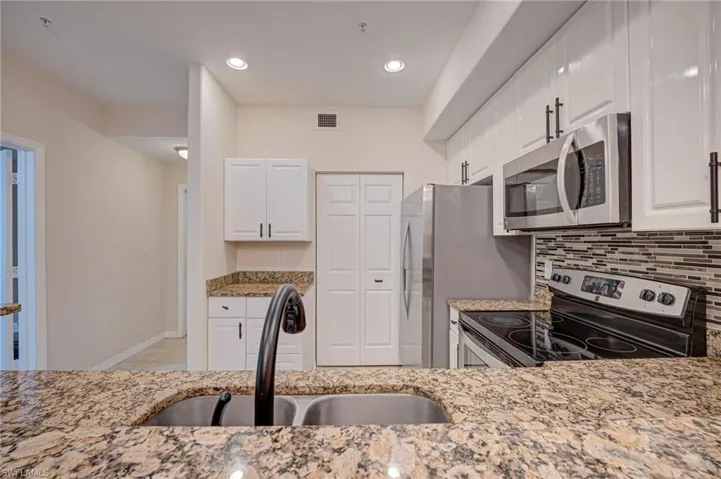 Granite Countertops, stainless steel appliances and tiled backsplash