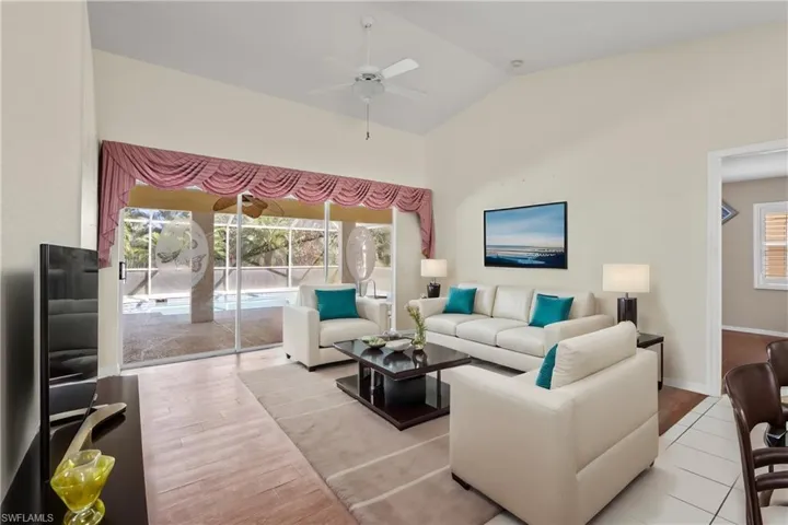 Virtually Staged Living room featuring high vaulted ceiling, ceiling fan, and light hardwood / wood-style floors