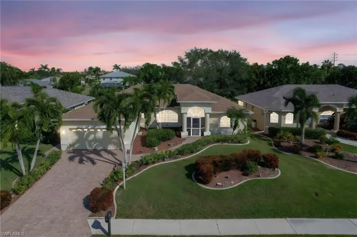 View of front of property featuring a yard and a garage