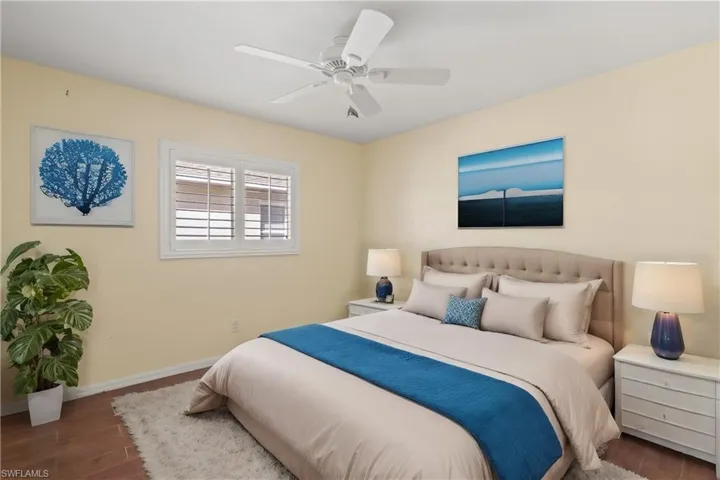 Bedroom with dark hardwood / wood-style flooring and ceiling fan