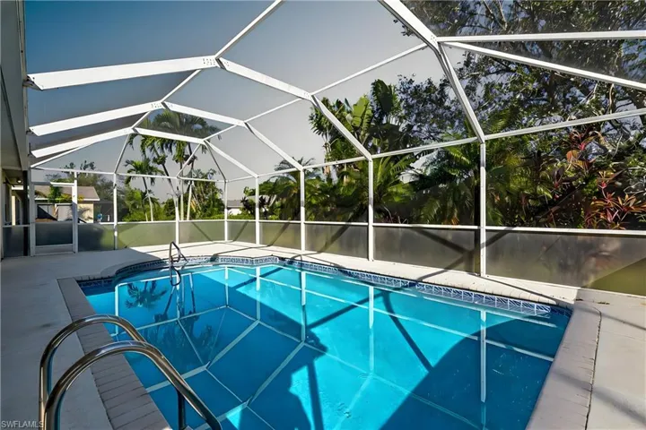 View of pool featuring glass enclosure