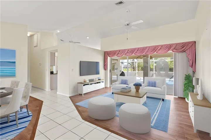 Virtually Staged Living room with high vaulted ceiling, ceiling fan, and light hardwood / wood-style floors