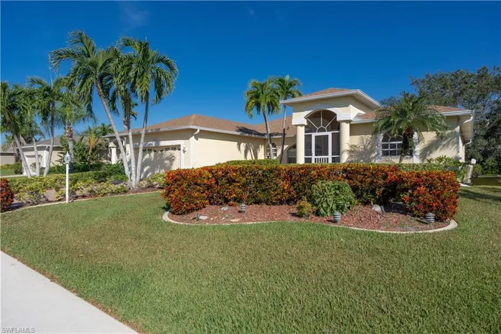 View of front of home featuring a front lawn and a garage