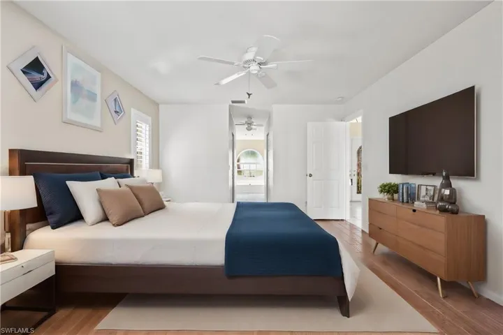 Virtually Staged Bedroom with ceiling fan and light hardwood / wood-style floors