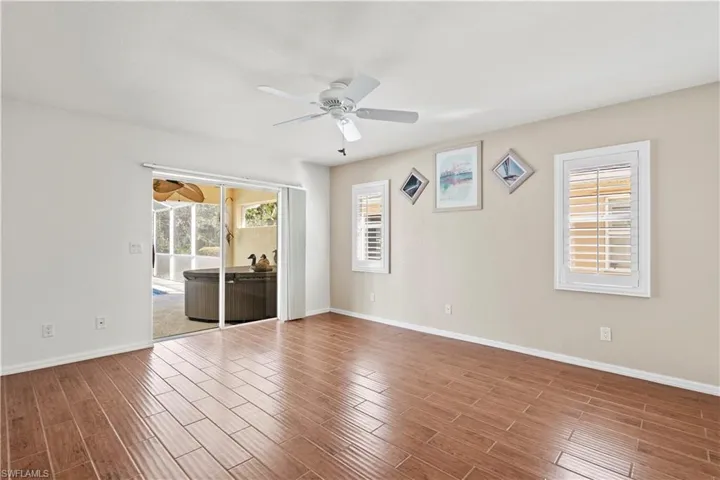 Unfurnished bedroom featuring ceiling fan and multiple windows
