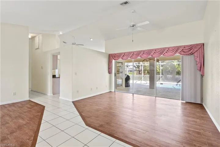 Spare room featuring ceiling fan, high vaulted ceiling, and light hardwood / wood-style floors