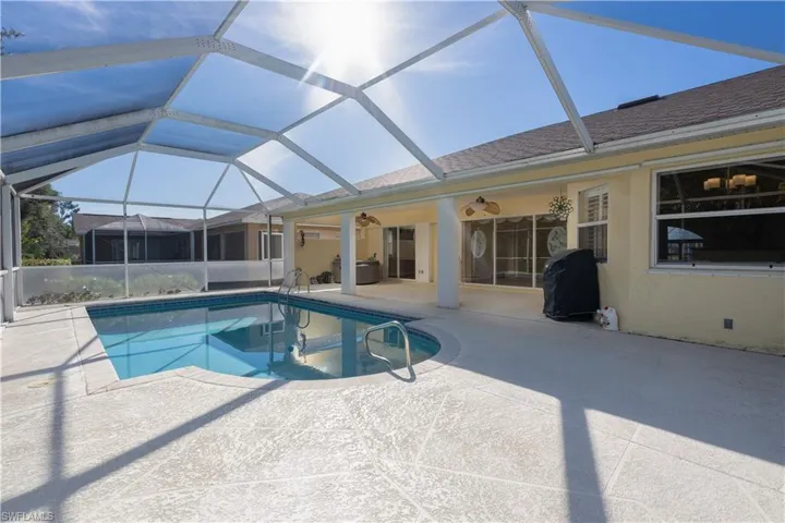 View of pool with ceiling fan, a lanai, and a patio