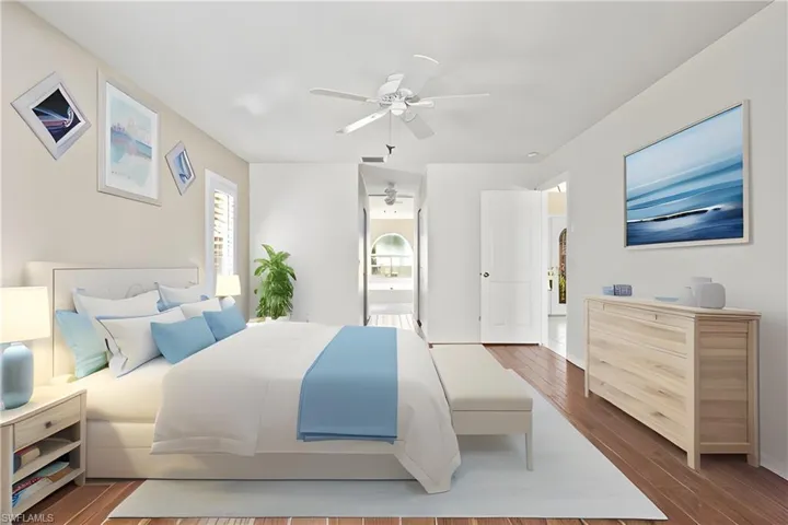 Virtually Staged Bedroom featuring ceiling fan, connected bathroom, and dark hardwood / wood-style flooring