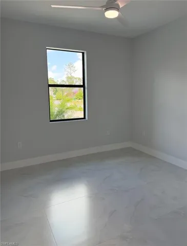 Spare room featuring baseboards and a ceiling fan