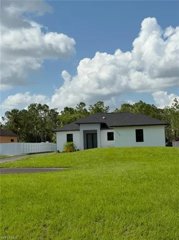 Rear view of house featuring stucco siding