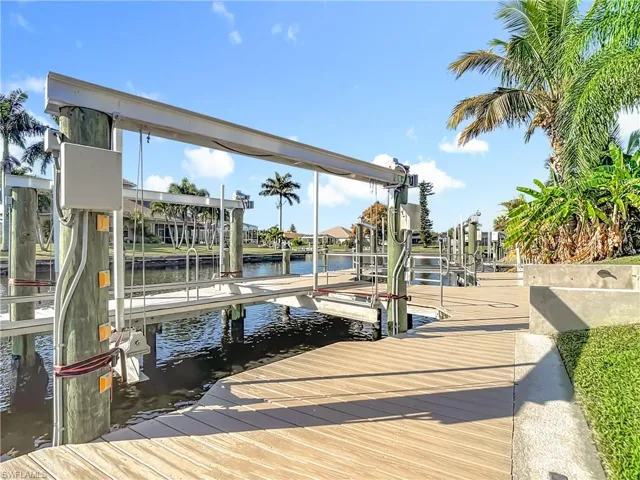 Dock area with a water view and boat lift