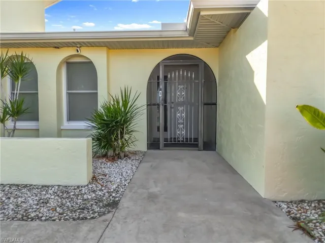 View of exterior entry featuring stucco siding