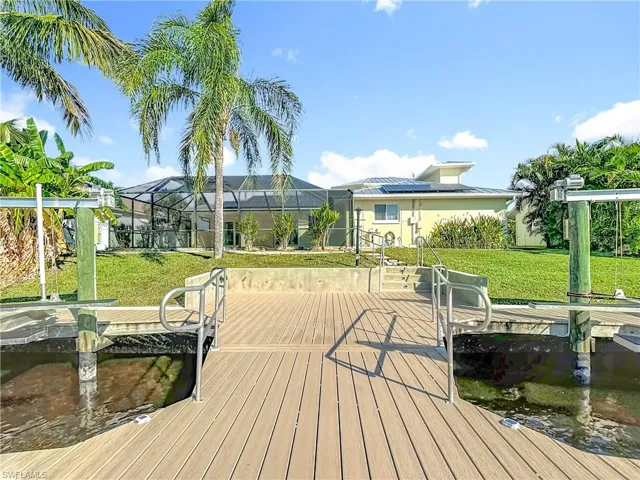 Dock area featuring a lawn, a sunroom, and a lanai